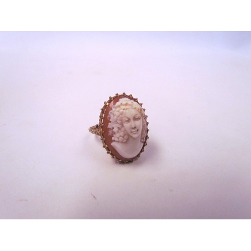 1039 - A cameo ring in high-profile mount, pierced basket and scroll shoulders, unmarked. Size Q, 9.8g