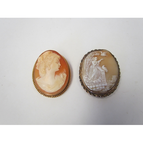 1040 - A 9ct gold-framed shell cameo brooch depicting a woman feeding birds from a balcony, and another sho... 