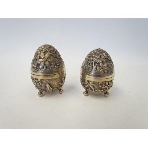 1047 - A pair of silver egg-shaped cruets by William Hutton & Sons with all over decoration depicting trees... 