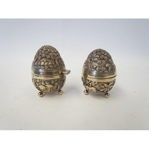 1047 - A pair of silver egg-shaped cruets by William Hutton & Sons with all over decoration depicting trees... 