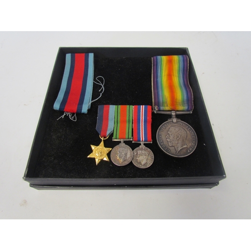 1048 - A bar of three miniature WWI service medals. A 1914-18 medal and ribbons.