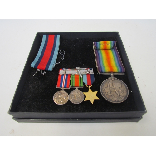 1048 - A bar of three miniature WWI service medals. A 1914-18 medal and ribbons.