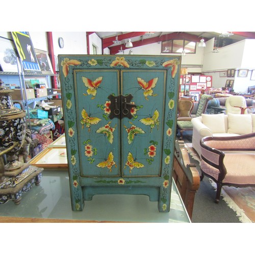 1028 - A 20th Century far-eastern wood two-door table-cabinet, the front lavishly painted with butterflies ... 