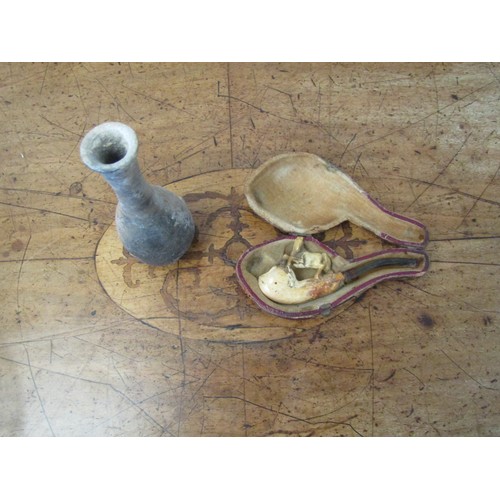 1068 - A small cheroot holder with carved meerchaum bowl, surmounted by a horse, and with amber mouthpiece.... 