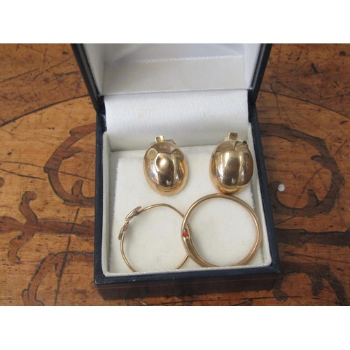 1071 - A pair of 9ct gold clip earrings and two slender finger rings, one as a serpent.