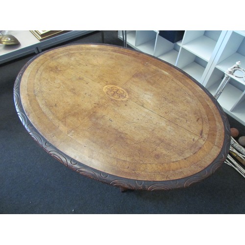 1058 - Victorian mahogany oval table top on five pillar pedestal base with scrolled feet.