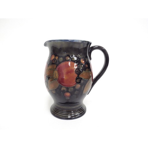 6647 - A William Moorcroft Pomegranate jug, 18.5cm tall