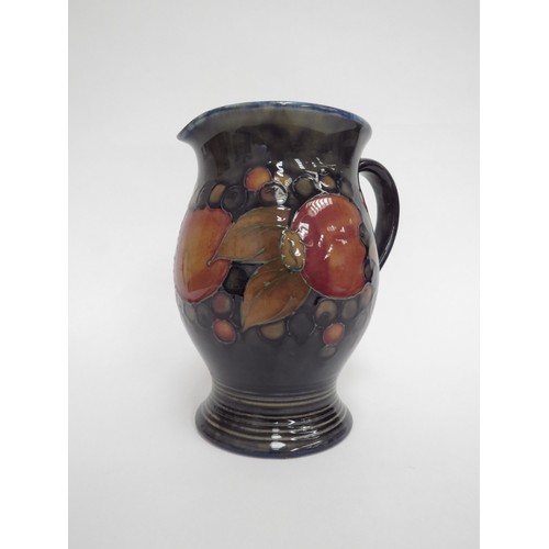 6647 - A William Moorcroft Pomegranate jug, 18.5cm tall