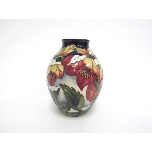 6654 - A Moorcroft Christmas Hellebore pattern vase, designed by Rachel Bishop, 13cm tall