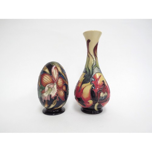 6658 - A Moorcroft slender form vase decorated with orange flowers by Emma Bossons, 17cm tall and a Moorcro... 