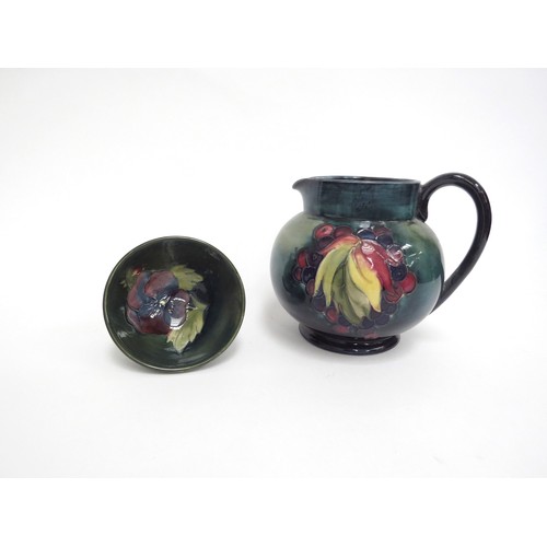 6659 - A William Moorcroft jug, Leaves and Berries pattern, of globular form, with blue/green mottled groun... 