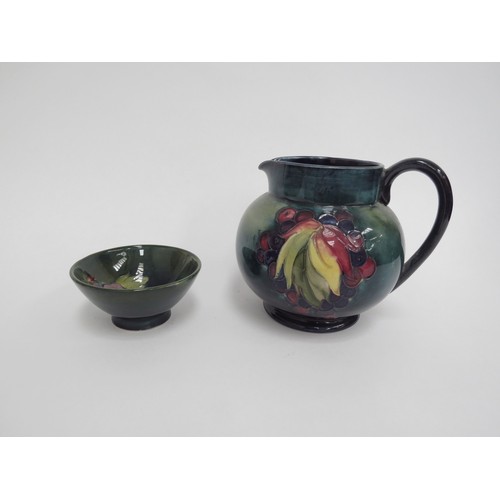 6659 - A William Moorcroft jug, Leaves and Berries pattern, of globular form, with blue/green mottled groun... 