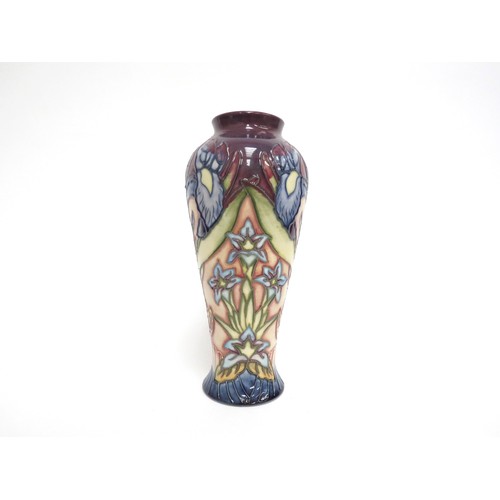 6625 - A Moorcroft vase decorated with blue irises and small blue flowers, monogrammed WM to base, second, ... 