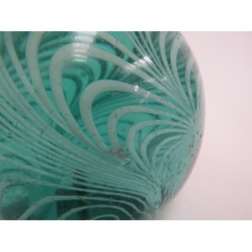 6605 - A large Victorian green glass dump with swirl inclusion, 11cm tall