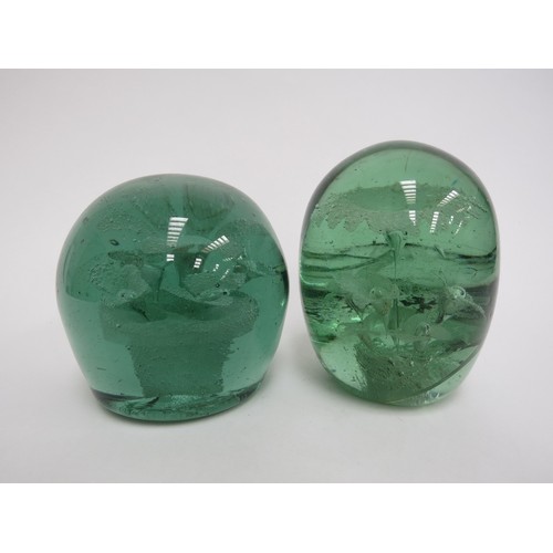 6606 - Two Victorian green glass dumps both with multiple flower inclusions, tallest a/f. 12.5cm