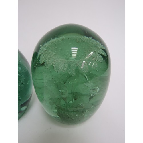 6606 - Two Victorian green glass dumps both with multiple flower inclusions, tallest a/f. 12.5cm