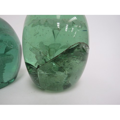 6606 - Two Victorian green glass dumps both with multiple flower inclusions, tallest a/f. 12.5cm