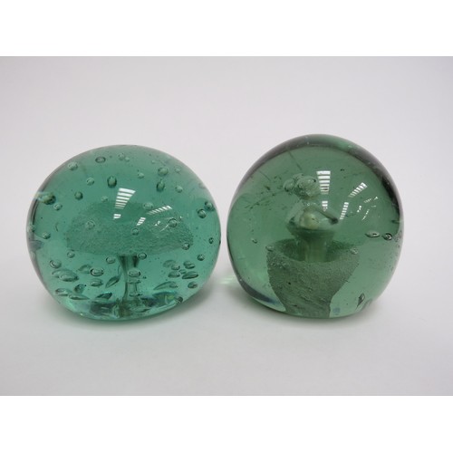 6593 - Two Victorian green glass dumps one with enclosed plaster figure the other with figure and bubble in... 