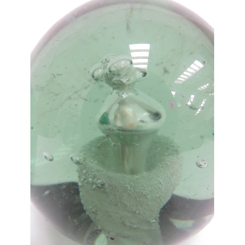 6593 - Two Victorian green glass dumps one with enclosed plaster figure the other with figure and bubble in... 