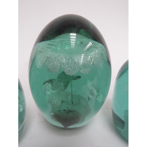 6589 - Three Victorian green glass dumps with foil flower inclusions, tallest 12cm