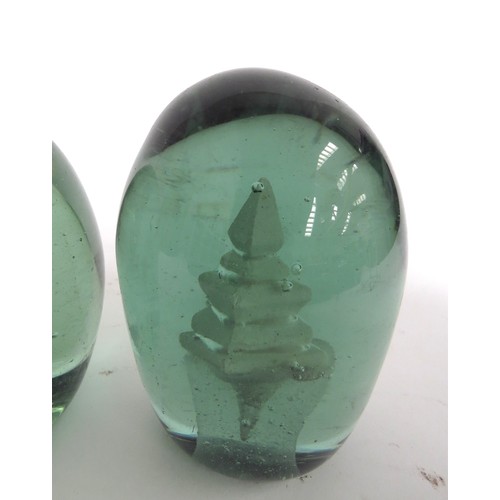 6588 - Three Victorian green glass dumps with enclosed plaster figures of a cockerel, young boy and temple,... 