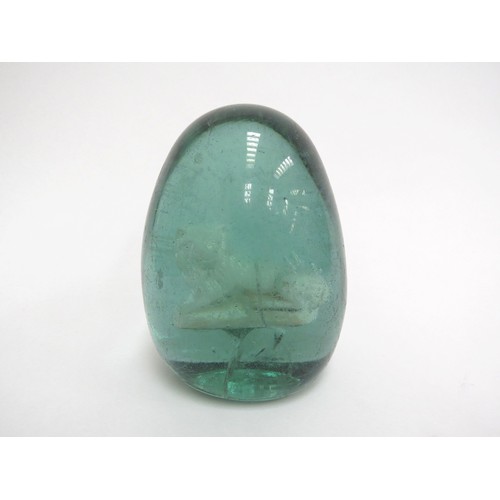 6597 - A Victorian green glass dump with an enclosed plaster figure of a Lion, 12.5cm tall