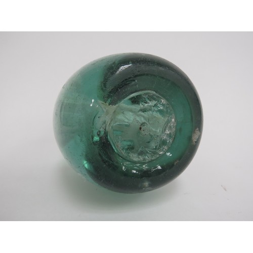 6597 - A Victorian green glass dump with an enclosed plaster figure of a Lion, 12.5cm tall