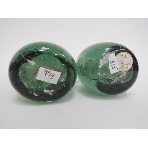 6595 - Two Victorian green glass dumps with enclosed plaster figures of Pug Dogs, 12cm tall