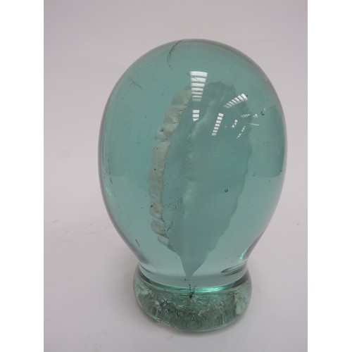 6596 - A large Victorian green glass dump with a plaster plaque inclusion 