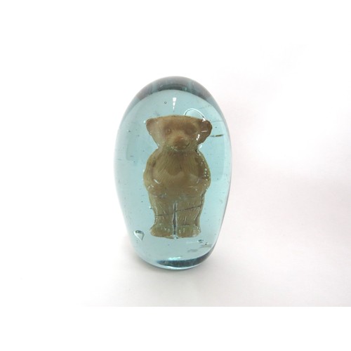 6599 - A Victorian green glass dump with an enclosed fired clay figure of a Teddy Bear, 9cm tall