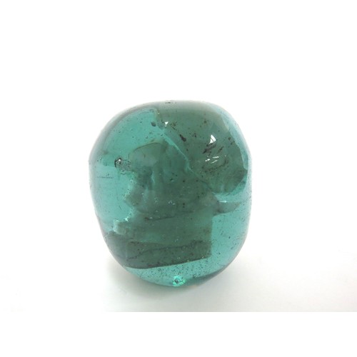 6598 - A Victorian green glass dump with encased image of a French Peasant, 10cm tall