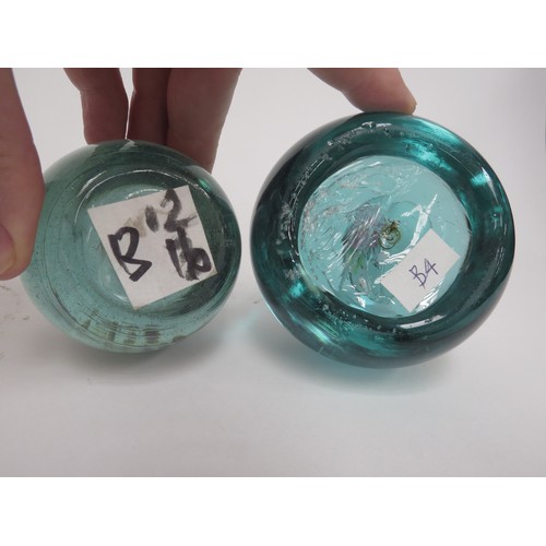 6587 - Two Victorian green glass dumps one with a painted ceramic plaque of flowers (broken in two) and the... 