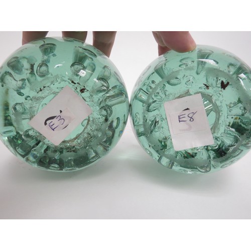 6590 - A Victorian green glass dumps both with bubble inclusions and large bubble to centres (near pair), 1... 