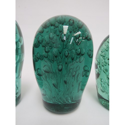 6580 - Three Victorian green glass dumps all with bubble inclusions, tallest 16cm