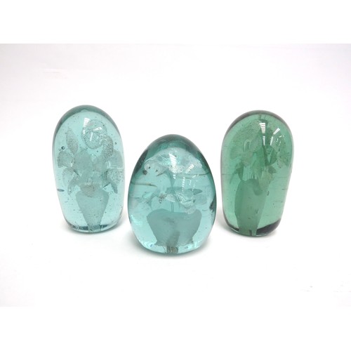 6581 - Three Victorian green glass dumps all with flower bouquet inclusions, tallest 11cm