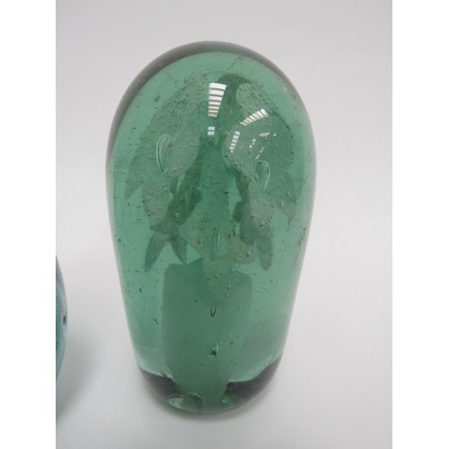 6581 - Three Victorian green glass dumps all with flower bouquet inclusions, tallest 11cm