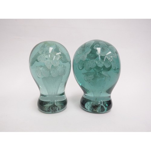 6591 - Two Victorian green glass dumps with flower bouquet inclusions, tallest 14cm