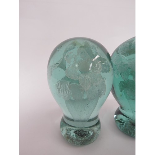 6591 - Two Victorian green glass dumps with flower bouquet inclusions, tallest 14cm