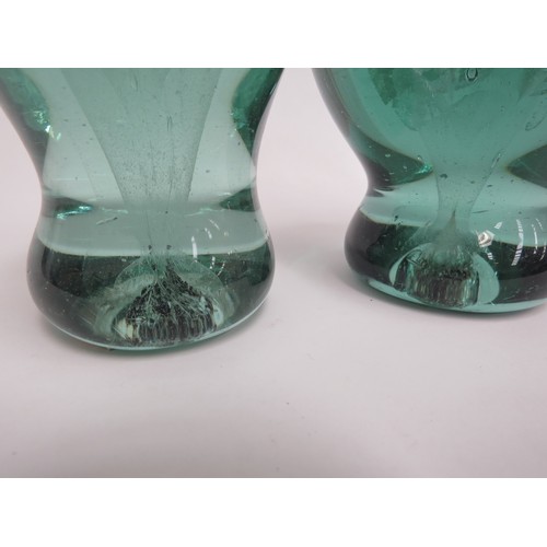 6591 - Two Victorian green glass dumps with flower bouquet inclusions, tallest 14cm