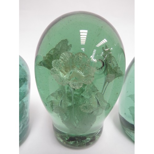 6584 - Three Victorian green glass dumps all with floral inclusions, tallest 13cm