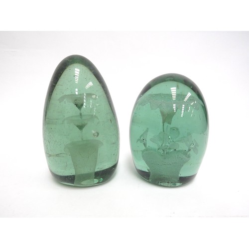 6582 - Two Victorian green glass dumps both with floral inclusions, tallest 15cm