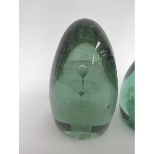 6582 - Two Victorian green glass dumps both with floral inclusions, tallest 15cm