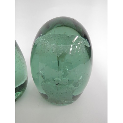 6582 - Two Victorian green glass dumps both with floral inclusions, tallest 15cm