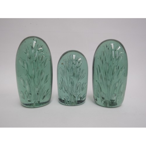 6577 - Three Victorian green glass dumps of elongated form all with bubble inclusions, tallest 14cm