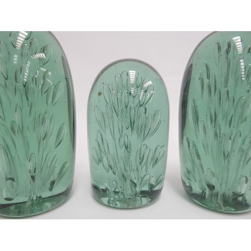 6577 - Three Victorian green glass dumps of elongated form all with bubble inclusions, tallest 14cm