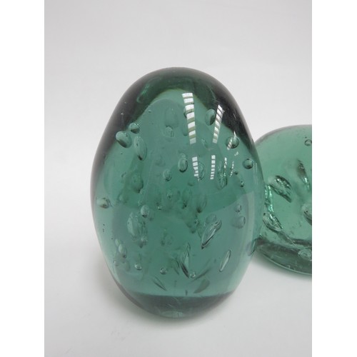 6576 - Two Victorian green glass dumps both with bubble inclusions, tallest 12cm