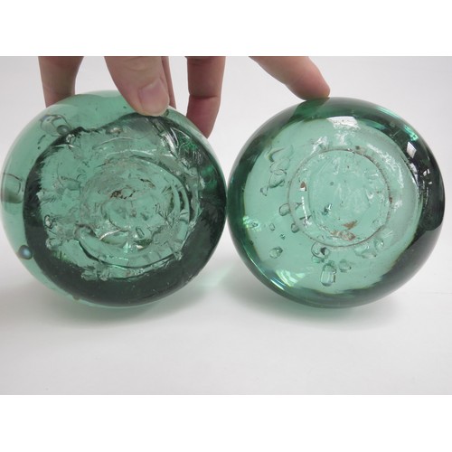 6574 - Two circular green glass dumps with bubble inclusions, tallest 12cm