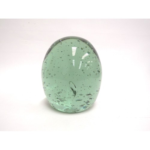 6579 - A large circular green glass dump with bubble inclusions, 16cm tall