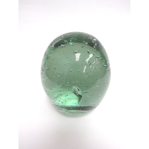 6579 - A large circular green glass dump with bubble inclusions, 16cm tall