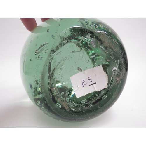 6579 - A large circular green glass dump with bubble inclusions, 16cm tall